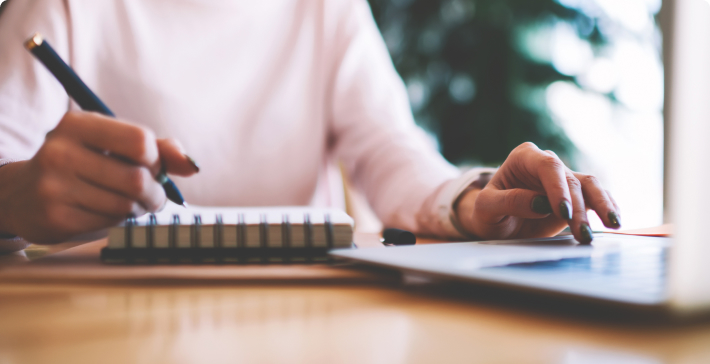 Woman's hands writing and typing