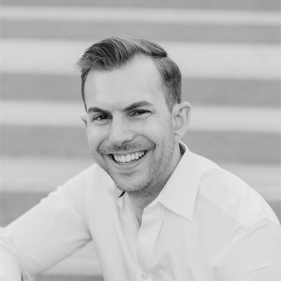 James Creech, headshot smiling at the camera, black and white image.